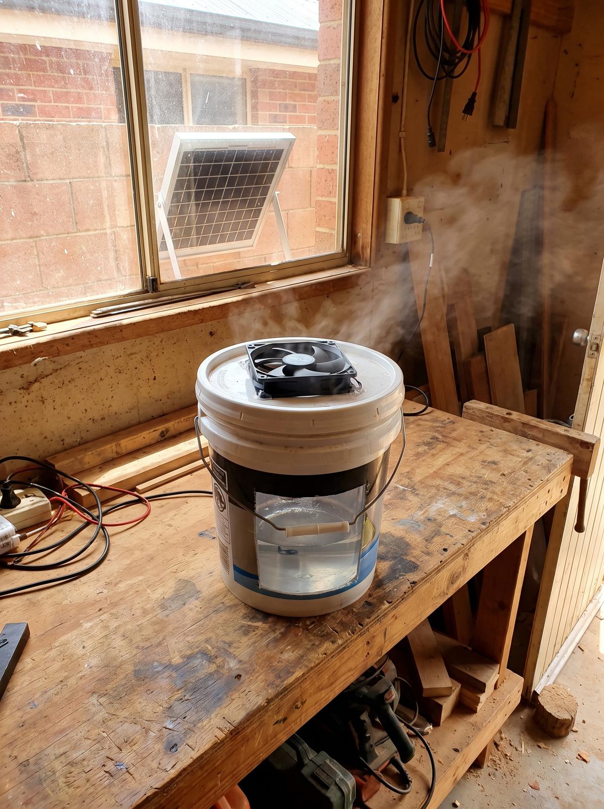 The finished swamp cooler running on a bench, blowing cool air