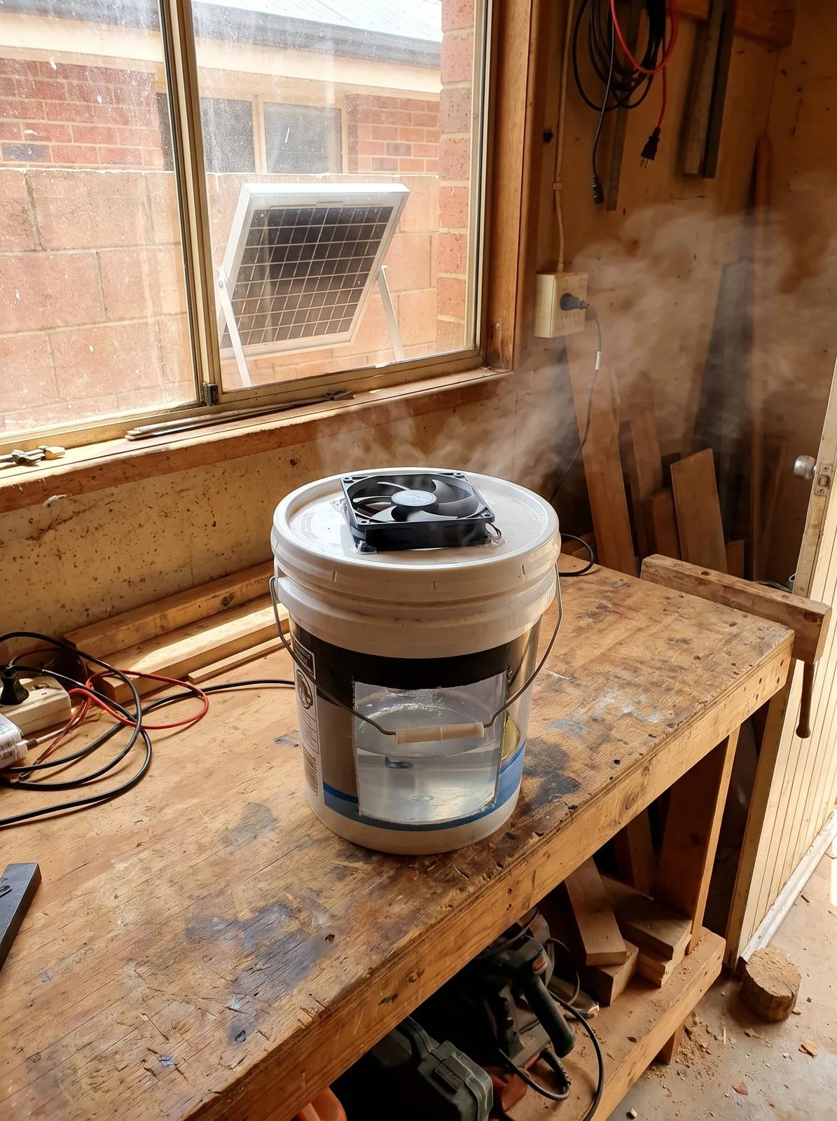 The finished swamp cooler running on a bench, blowing cool air